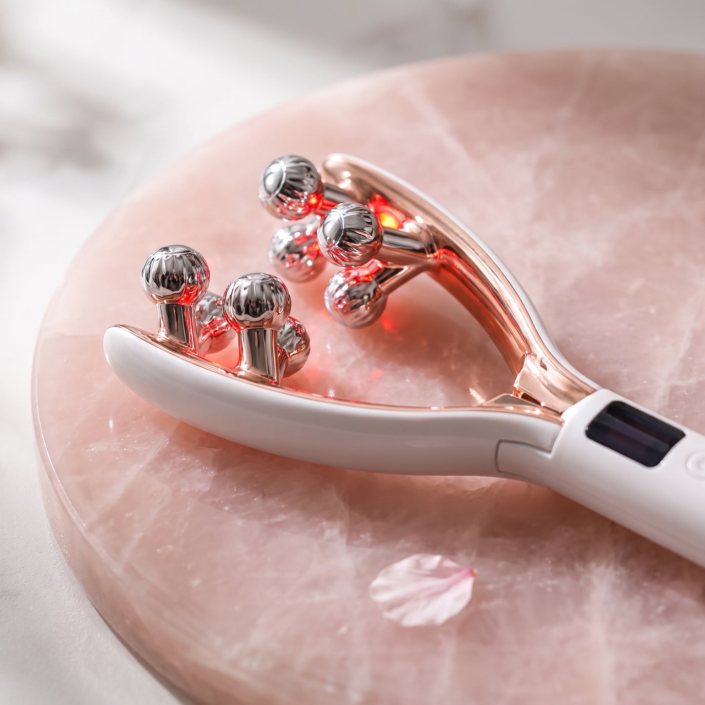 Lumiglo Sculpt facial massager, four chrome rotating heads with red light